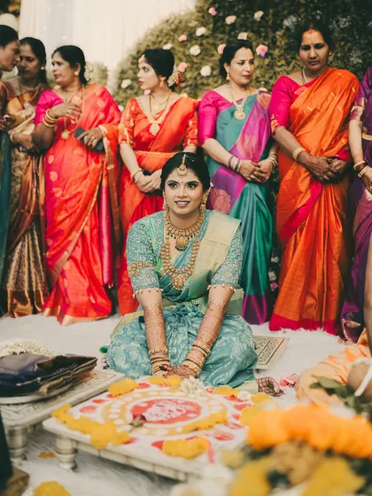The bride during her wedding ceremony, looking serene and beautiful in a different saree. This shows the versatility of her bridal look for different rituals.