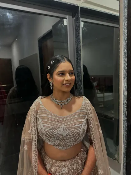 Her sangeet look is all about understated elegance, with a focus on fresh skin and a simple, chic hairstyle.