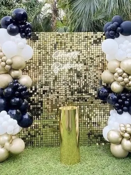 This outdoor 25th birthday party setup is all about glamour. I used a circular balloon arch against a green hedge wall, a "Happy Birthday" neon sign, and large, illuminated marquee numbers to create a stunning photo-op area for the celebration.
