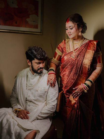 An elegant, posed portrait taken away from the main ceremony. The dramatic lighting and classic pose give this shot a timeless, regal feel.