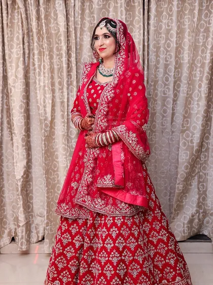A full-length view of this gorgeous red Nikah outfit. The makeup is balanced to ensure the bride is the star of the show, looking radiant from head to toe.