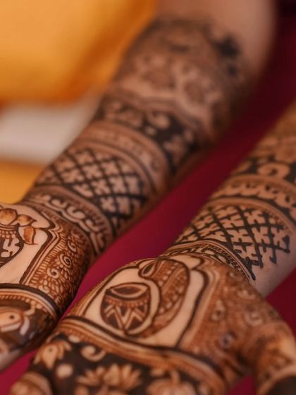 A close-up of the palm, showing the detailed application of auspicious kalash and swastika motifs.