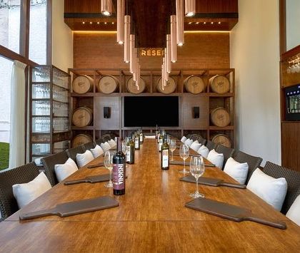 Our 'Cave de la Reserve' offers an enchanting space for private tastings and events. The long table, set against a backdrop of wine barrels, creates a vintage masterpiece atmosphere for any gathering.