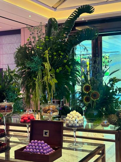 The combination of lush greenery and decadent chocolates creates an irresistible and luxurious experience for guests.