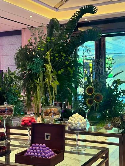 The combination of lush greenery and decadent chocolates creates an irresistible and luxurious experience for guests.