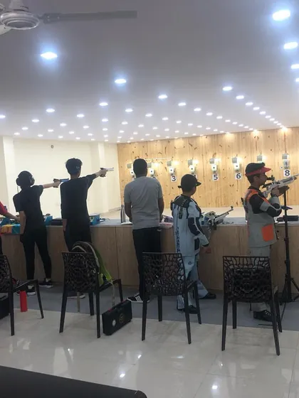 A wide shot of the range with shooters participating in a local tournament, using both pistol and rifle.