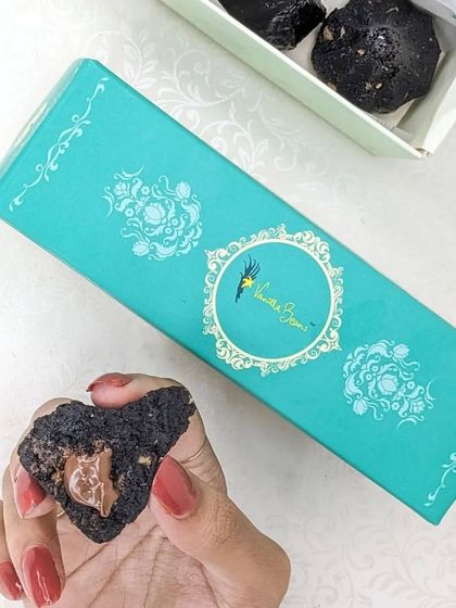 A peek inside our Cake Modak box, showing a Chocolate Modak broken open to reveal its rich, gooey center.