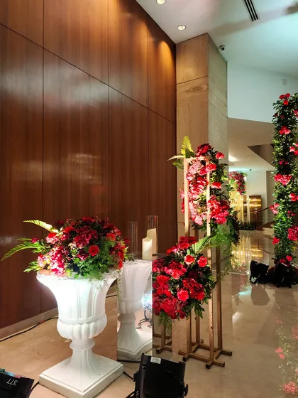 Another view of the elegant floral decor lining the hallway. We use a combination of tall and low arrangements to create visual interest and a sense of luxury.