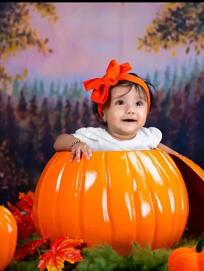 A happy smile from inside the pumpkin. This is a fun and unique theme that families love, especially for babies born in the autumn months.