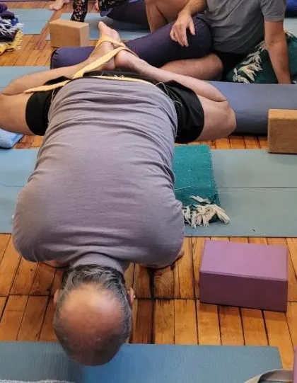 A forward bend with bound feet.