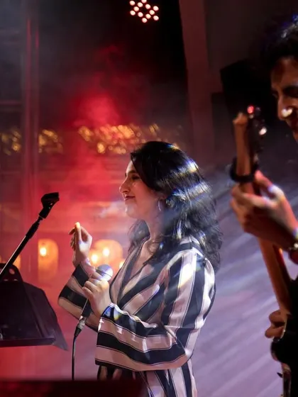 Sharing a smile on stage with my guitarist. The non-verbal communication between us during a live set is key to a seamless performance.