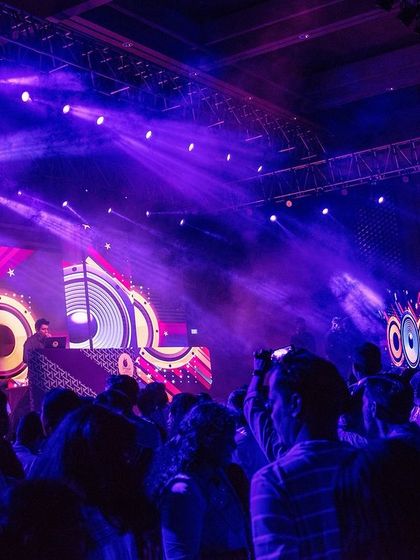 A wide view of the impressive stage and lighting production for the corporate gala.