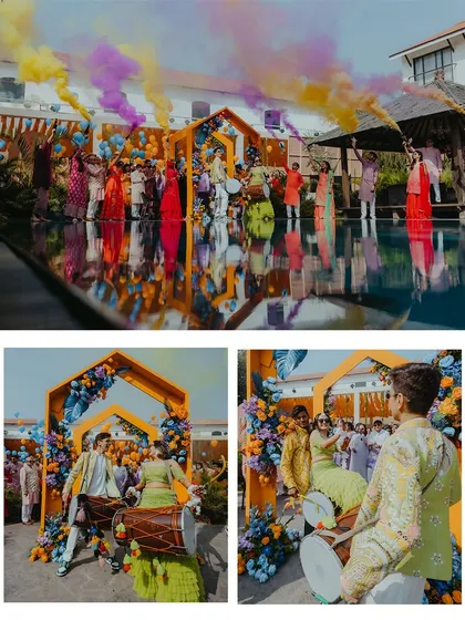 The couple's grand entrance to their poolside Haldi party, complete with dhol players and colorful smoke bombs.