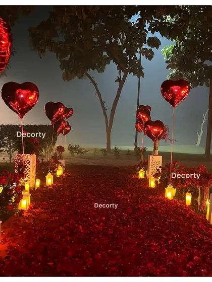 The candle and balloon-lined pathway at night, creating an enchanting and romantic atmosphere for the proposal.