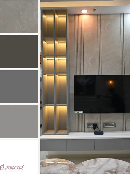 This TV unit showcases a cool, contemporary grey color palette. The back wall features a combination of fluted panels and smooth laminate, with a built-in open shelving unit illuminated by warm backlighting.