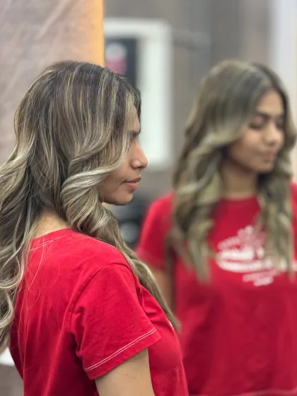 A side profile of a beautiful student makeover. The highlights are placed to create a contouring effect, and the spiral curls add a touch of glamour.
