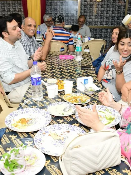 Guests engaged in lively conversation over a delicious meal. We love the vibrant atmosphere.