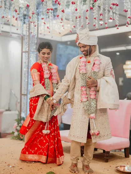The couple walking hand-in-hand after their wedding ceremony.