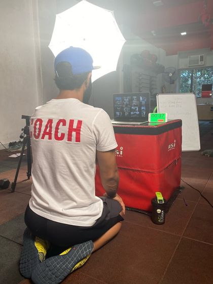 A behind-the-scenes look at me coaching an online class. I bring the same energy and expertise to my virtual sessions as I do in the gym.