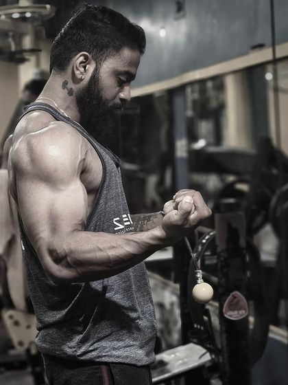 Lift. Sweat. Conquer. A shot capturing the definition and vascularity that comes from intense training and dedication.