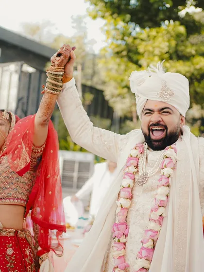 The pure elation of being married. The groom's excited expression as he holds his bride's hand says it all.