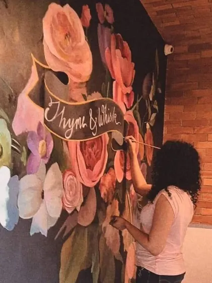 Floral art is a signature part of my work. Here I am adding the final touches to a large-scale floral mural for the Thyme & Whisk restaurant. I believe bringing elements of nature indoors adds a unique energy and beauty to any commercial space.