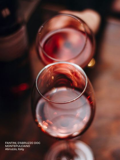 An overhead view of two glasses of Fantini, a Montepulciano from Abruzzo, Italy. This deep red is just one of the many distinctive wines you can discover on our list.