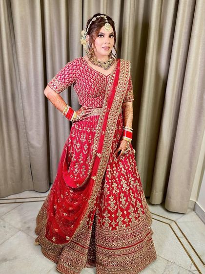 A full-length pose that highlights the complete silhouette of her bridal look.