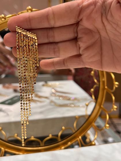 The same beautiful tassel earrings in a classic gold finish. The way they catch the light and move is absolutely mesmerizing.