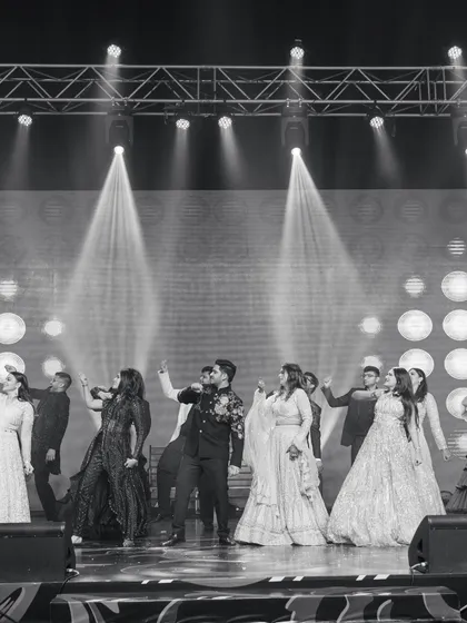 A black and white shot capturing the energy of a family finale. The entire group is in sync, creating a powerful and timeless image of togetherness.