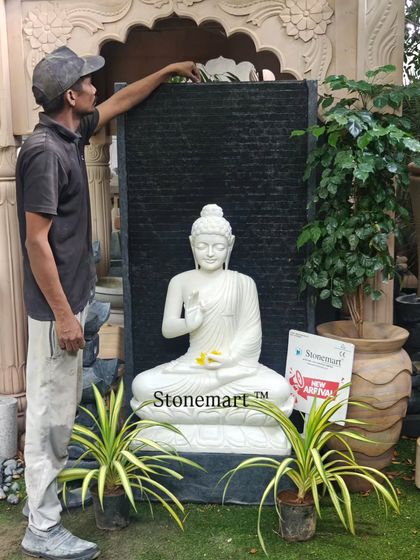To give a sense of scale, one of my team members stands beside the 5-foot Blessing Buddha fountain. This demonstrates the impressive size and craftsmanship of the piece.