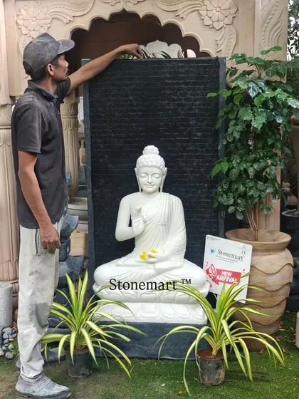 One of our team members stands beside the 5-foot Blessing Buddha fountain to give a sense of its impressive scale. This piece is designed to be a significant focal point in any large indoor or outdoor area.