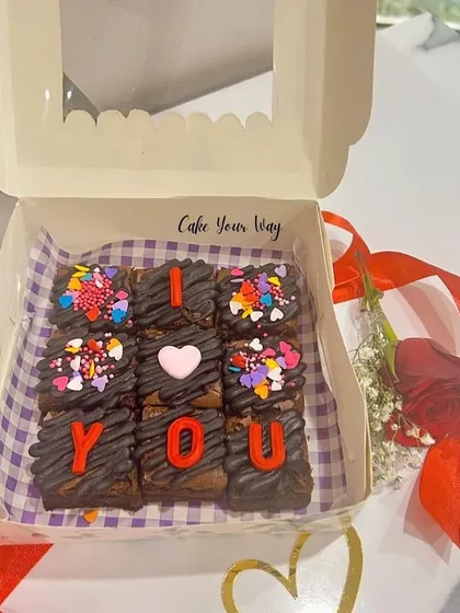 Say it with brownies. This box of nine fudgy brownies spells out 'I love you' and is a fun and delicious alternative to a traditional Valentine's gift.