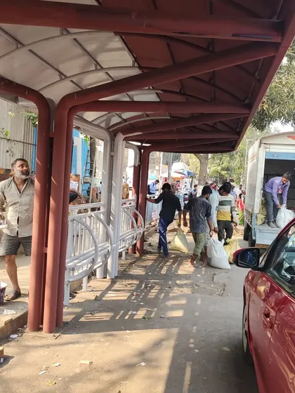 A view of the new rickshaw stand shelter under construction. This structure was a key element of the plan, designed to provide weather protection and create an organized queuing system for commuters.