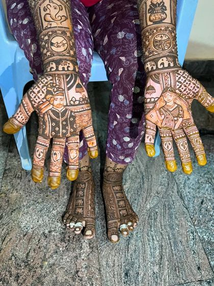 The complete bridal look for Manasa, with custom portrait mehendi on both her hands and feet.