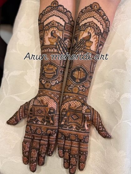 This design features beautiful peacocks and elephants, along with traditional kalash and floral patterns.