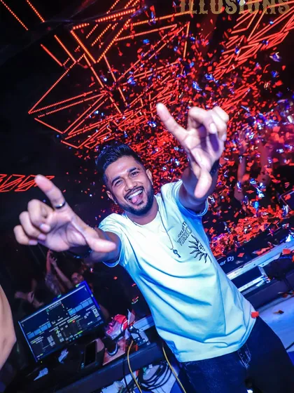 A fun, energetic shot of me with my tongue out, throwing up hand signs during a confetti drop. It's all about having a good time.