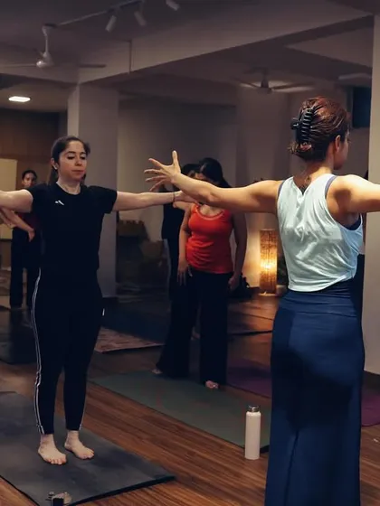 Students engaged in a seated warm-up, opening the chest and shoulders. Each class builds progressively, preparing the body for more complex movements.