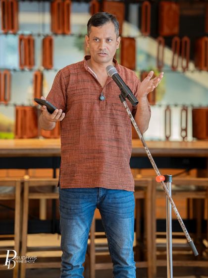 A poet passionately delivering his piece. Our themed events encourage deep exploration of important social and personal topics.