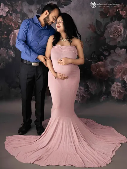 A classic couple's pose against a romantic floral backdrop. The way they look at each other tells a story of love and shared dreams.