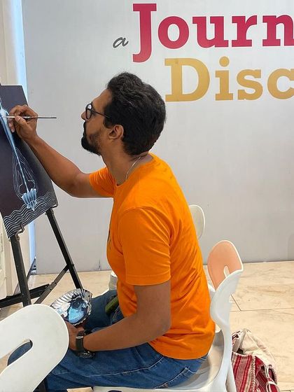 Another angle of me working on the yoga-themed painting, showing the initial layers and composition.