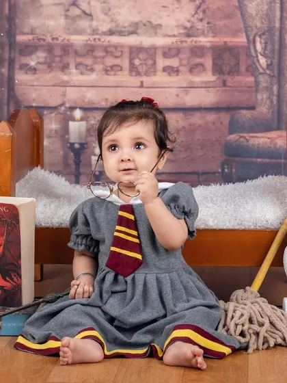 This little witch is taking a break from her magic lessons. A candid and cute moment from a Harry Potter themed session.