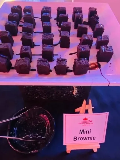Our Mini Brownies are a perfect bite-sized indulgence. Drizzled with chocolate sauce, they are a hit at parties and corporate events, easy for guests to enjoy.