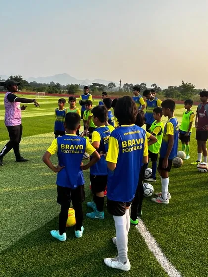 A coach from our partner club, NorthEast United FC, gives instructions to a group of young players during a camp. This highlights the high level of coaching our players receive.