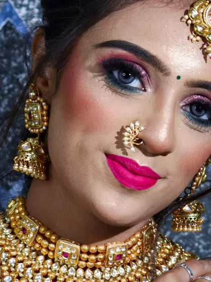 A striking close-up of the model, her blue contact lenses making the pink eye makeup pop.