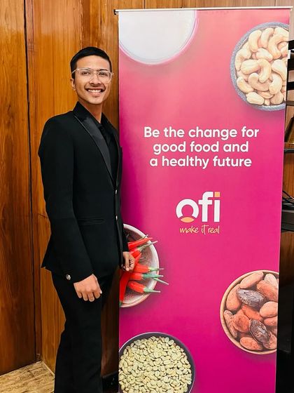Posing by the OFI event banner. It was a pleasure to be part of their event and help them 'make it real' with a touch of magic.