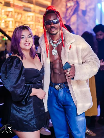 A guest posing with an international artist who visited the club.