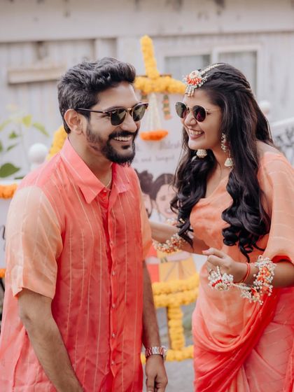 Haldi functions are always fun. This candid shot captures the joy of the couple, with the bride looking fresh and radiant.