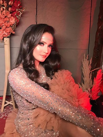 A seated portrait that captures the elegance and allure of this glamorous evening look.