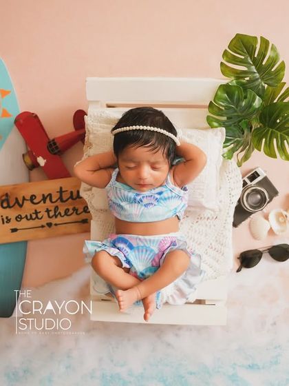 The full beach-themed newborn setup, showing the baby surrounded by all the elements of a perfect seaside adventure.